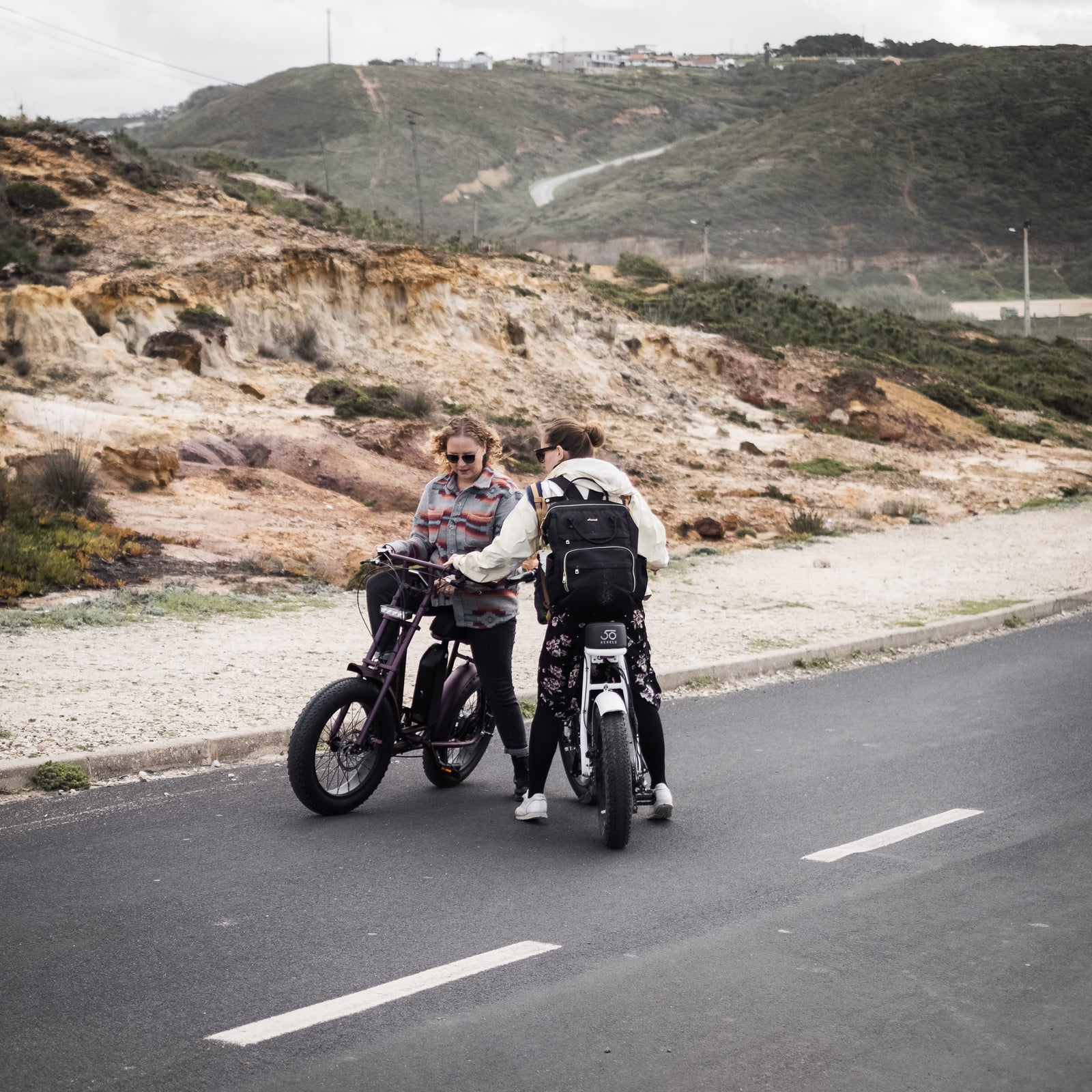 Women explaining how to ride an e-bike on a 50 Rebels V-Series electric bycicle